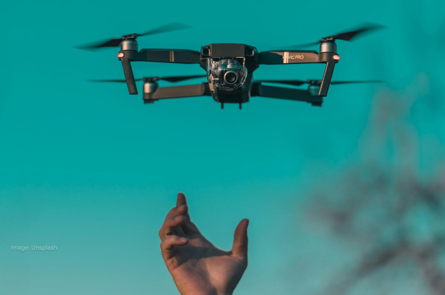drone-flying-above-hand-in-sky.jpg