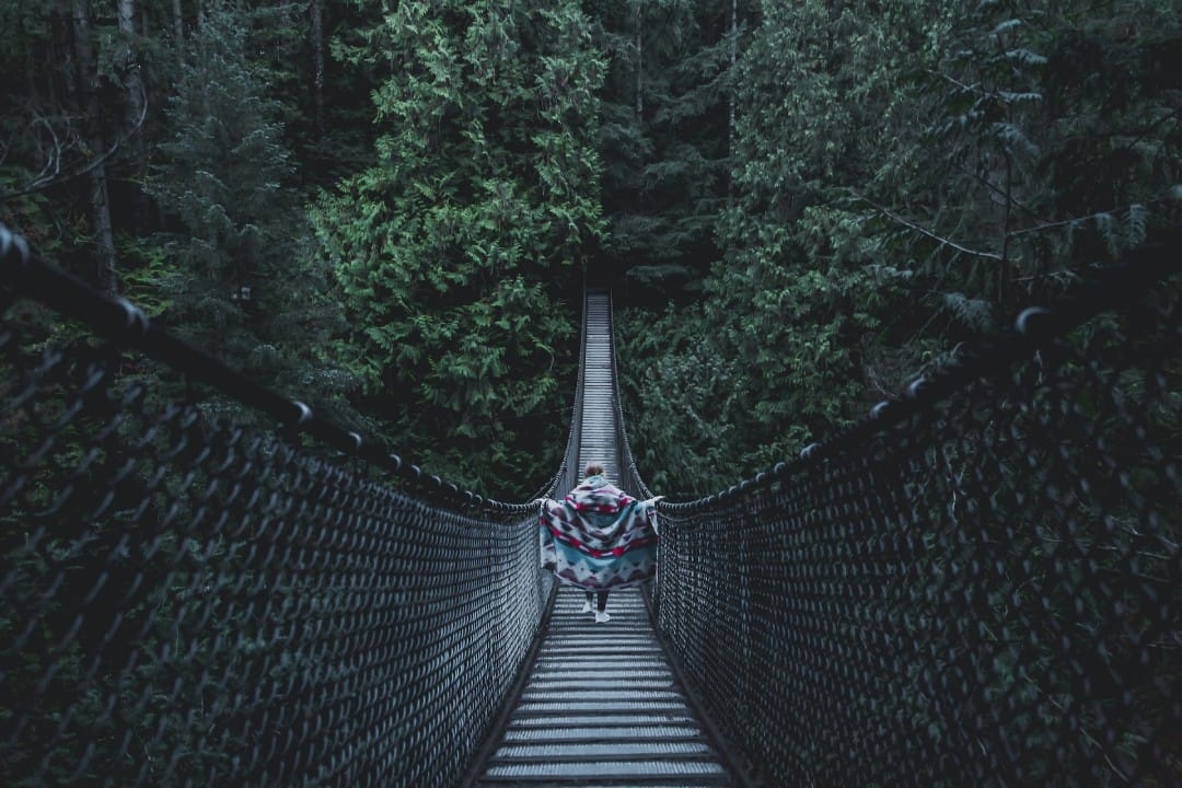 woman-walking-along-wooden-bridge.jpg