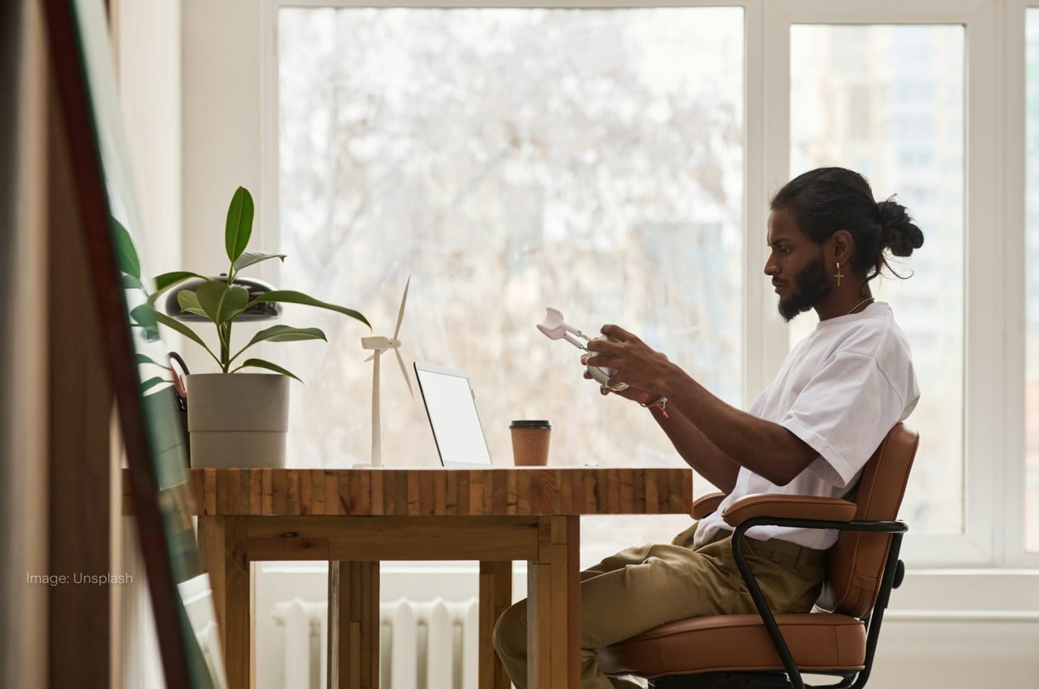 a-man-works-at-his-desk-near-a-window.jpg