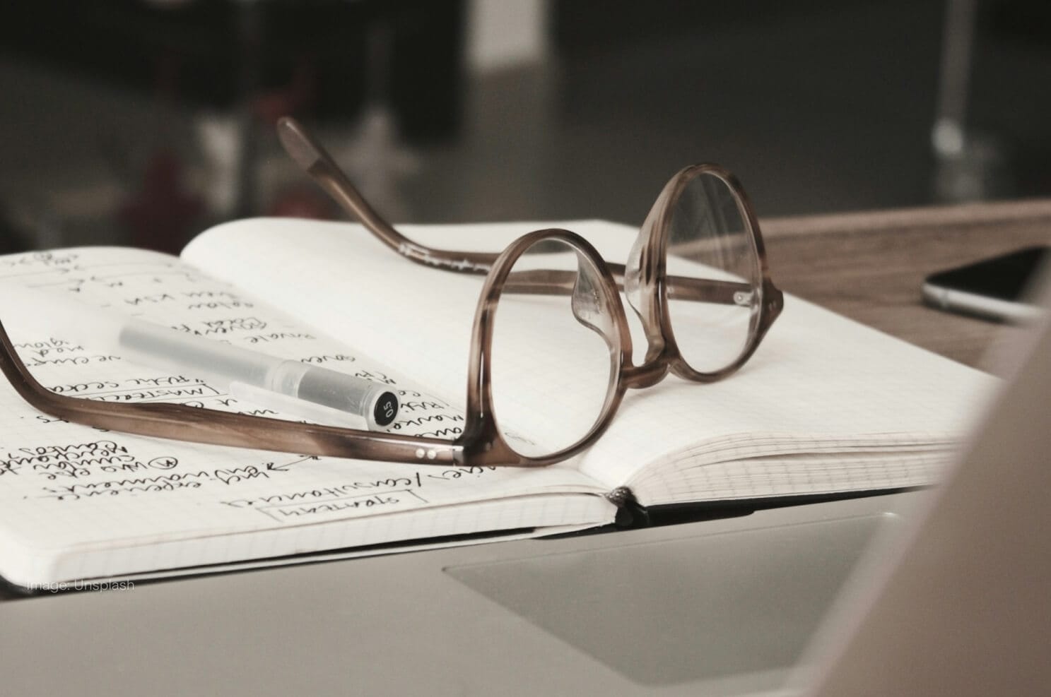 glasses-on-book-with-laptop.jpg