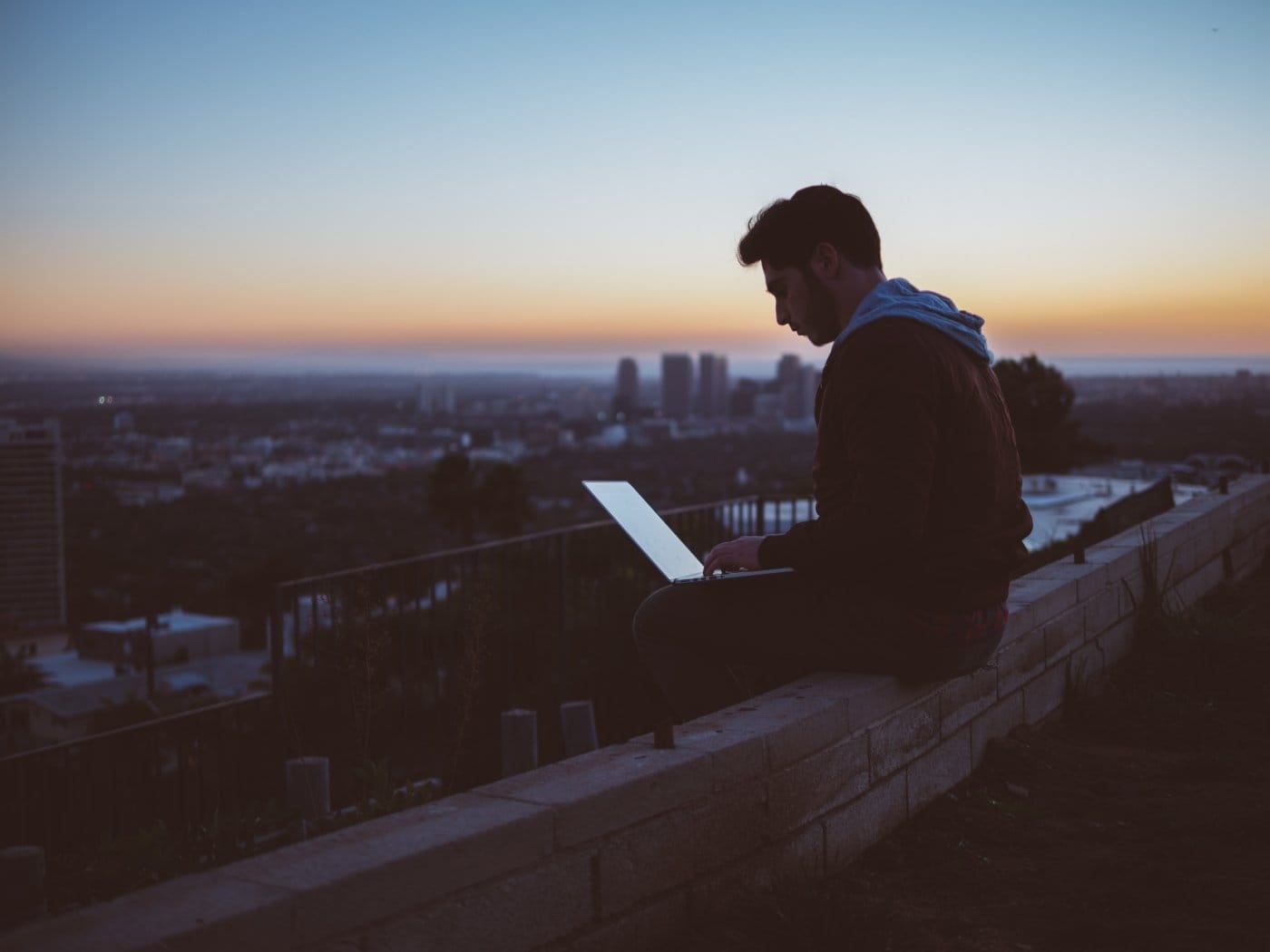 man-sitting-on-roof-with-laptop.jpg