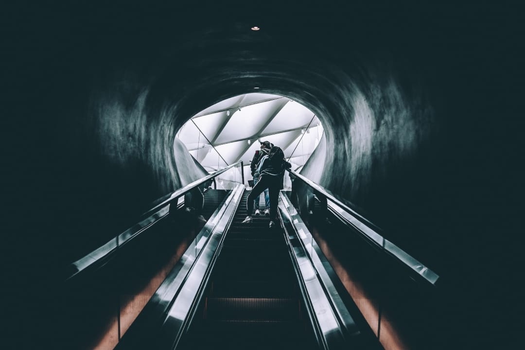 person-going-up-escalator.jpg