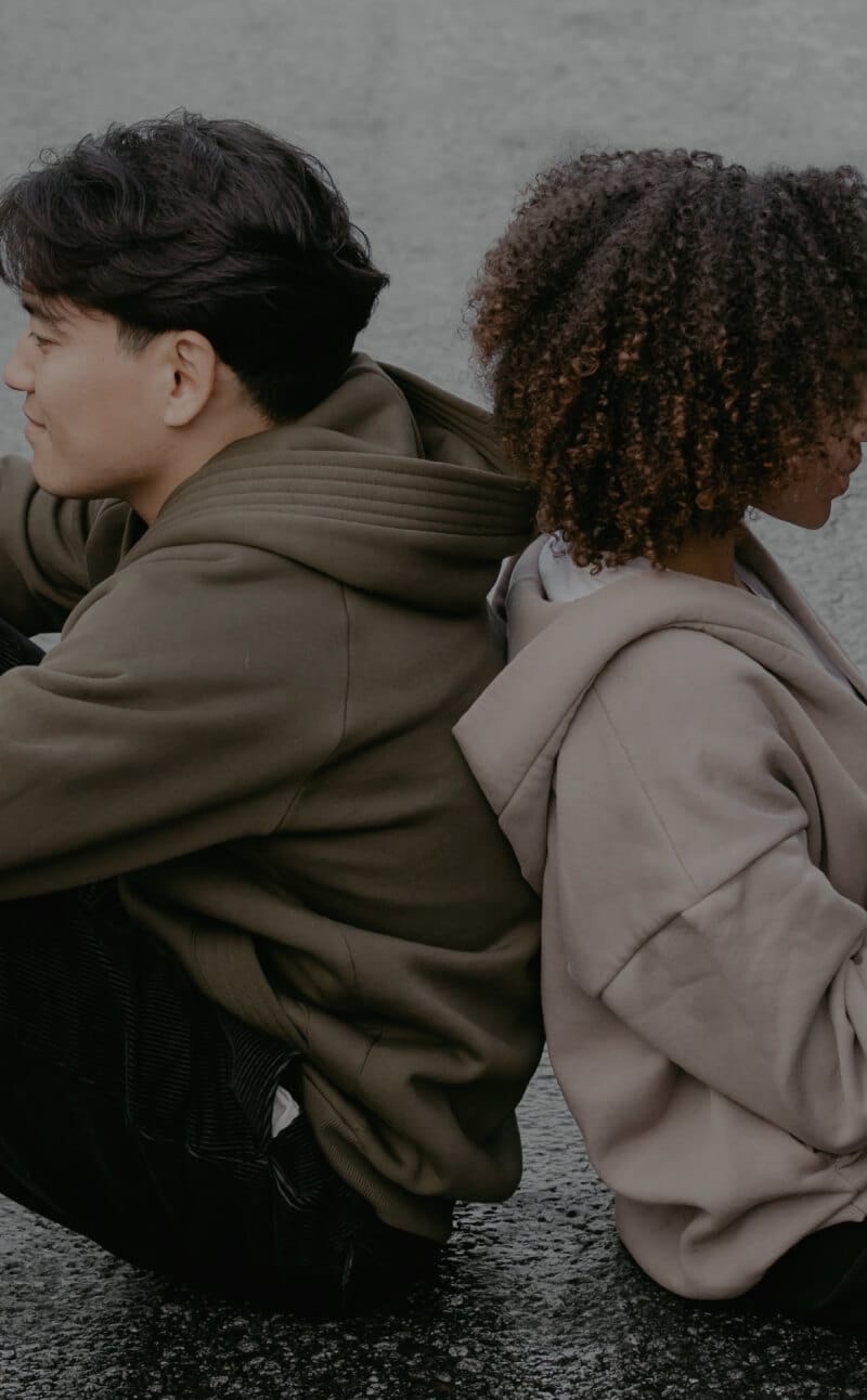 two-people-on-phones-backs-together-mobile.jpg