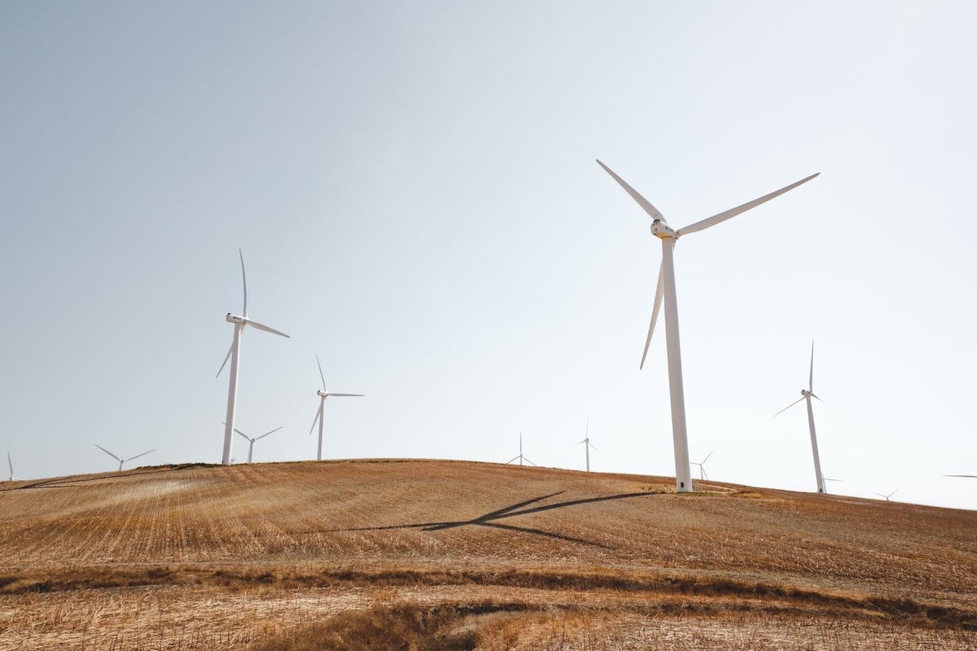 white-wind-turbines-in-dry-field.jpg
