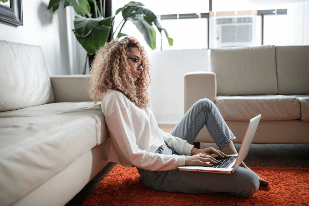 woman-sitting-on-floor-with-laptop.png