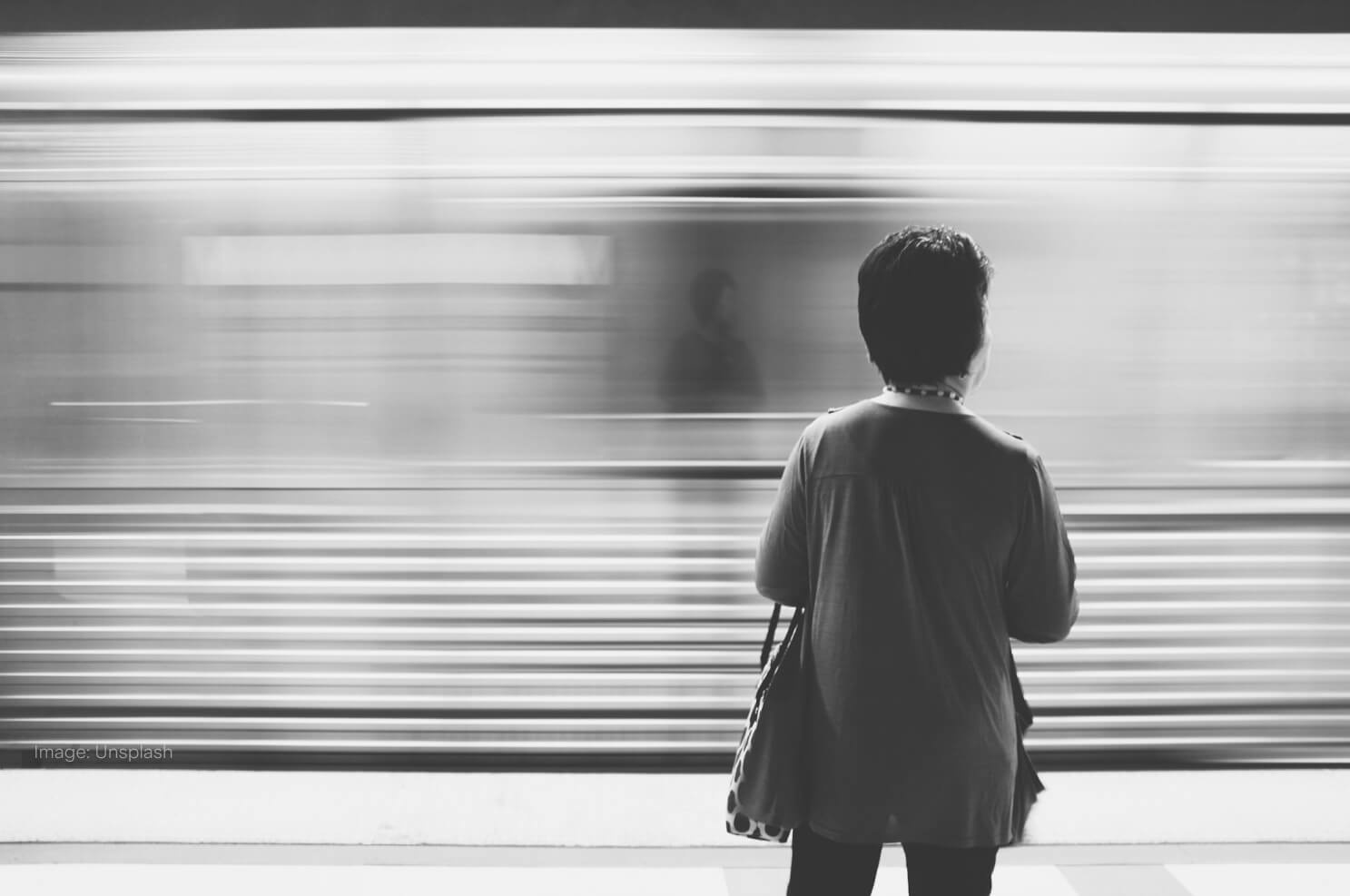 woman-with-bag-train-going-by.jpg
