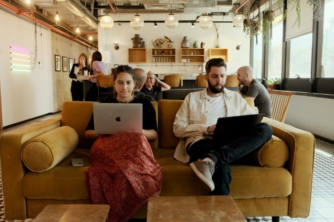 man-and-woman-with-laptops-sitting-next-to-each-other.jpg