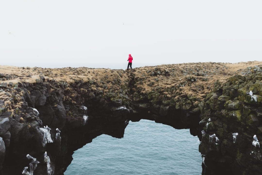person-standing-on-natural-bridge.jpg